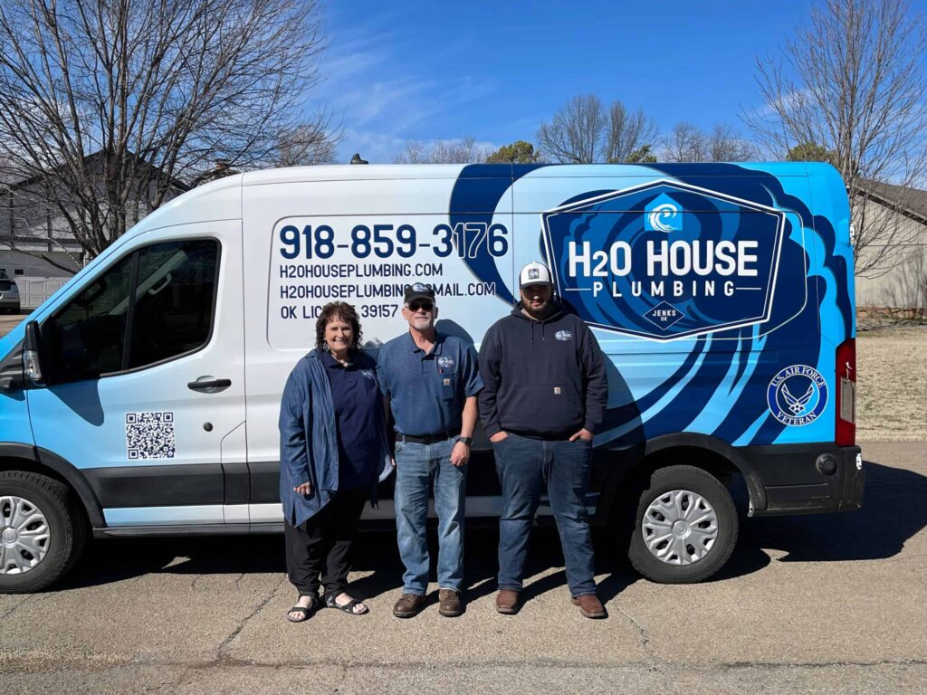 H2OHouse Plumbing, LLC plumbers in front of the company van on-site for plumbing services in Tulsa